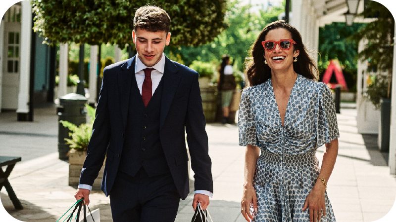 A man and a woman walking and smiling