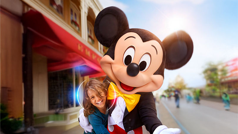 Mickey Mouse is hugging a person