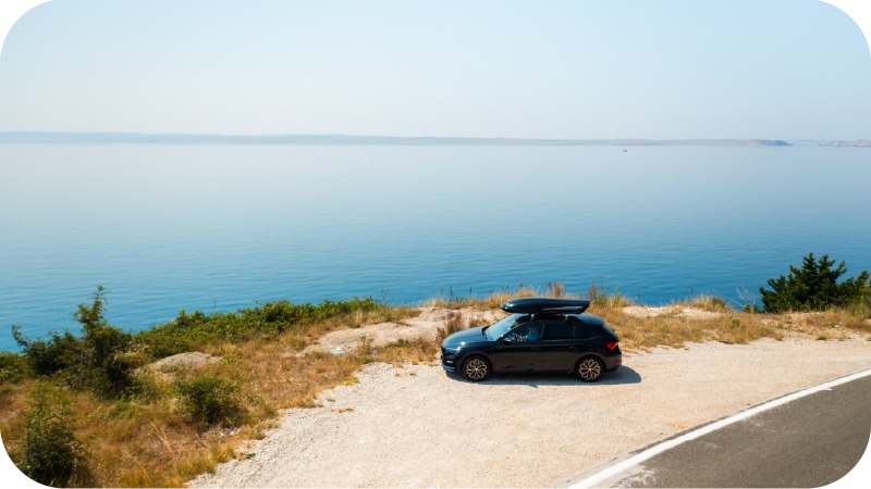 A car parked near the sea